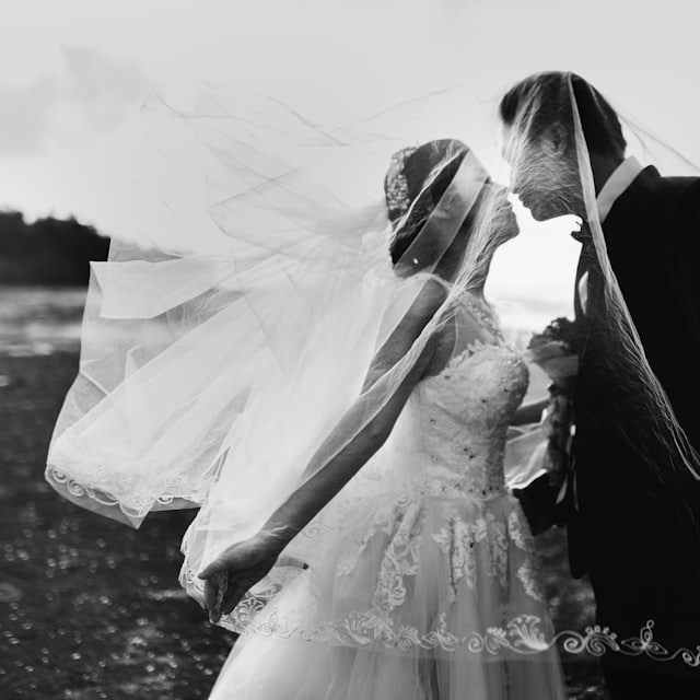 Black-and-white portrait of a couple beneath the veil